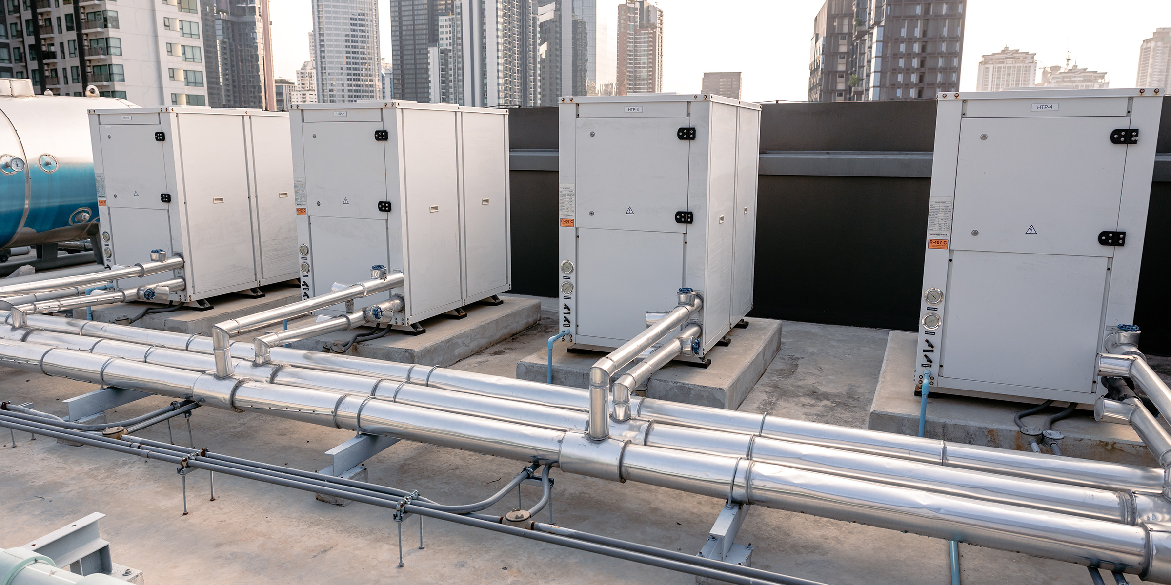 Heat pumps on the roof of a high rise urban building.